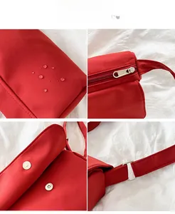 Detailaufnahme der wasserdichten roten Umhängetasche aus Nylon mit Wassertropfen und Zubehör