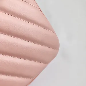 Close-up of pink quilted faux leather handbag showing fine stitching and texture