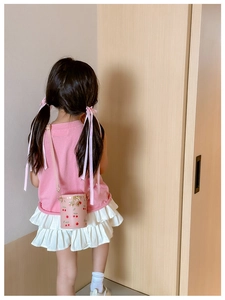 Sac seau rose avec motif cerise pour fillettes porté par un enfant mannequin