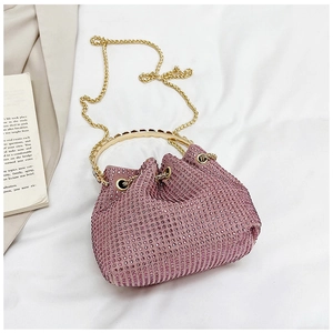 Close-up of pink rhinestone bucket bag with golden round handle and chain strap detail