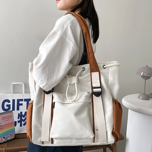 Large canvas tote bag with contrast brown straps and multi-pocket for daily commuting