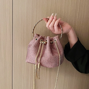 Pink rhinestone bucket bag with gold ring handle and chain strap for evening events
