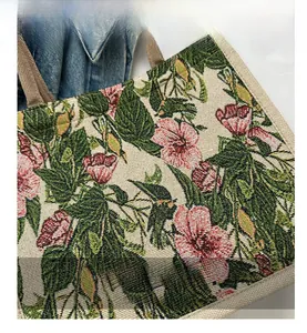 Close-up of vintage floral jacquard texture and beige canvas strap on a large tote bag