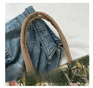 Close-up of tropical leaf jacquard fabric and durable brown rope handles on canvas tote bag