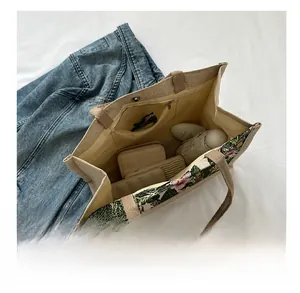 Detail view of large canvas tote bag showing interior magnetic clasp and storage capacity