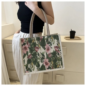 Close-up of retro floral canvas tote bag featuring reinforced handle and fabric texture