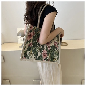 Detail view of vintage floral tote bag with pink flowers and light green leaf pattern