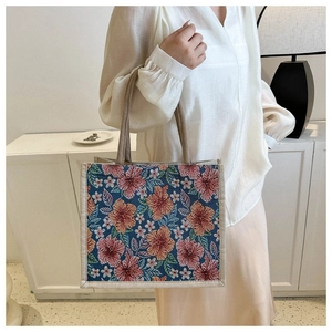 Close-up of retro floral tapestry tote bag with canvas handles in a modern home setting