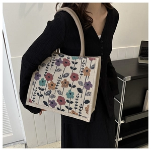 Detailed side view of floral canvas tote bag featuring vibrant colorful flower patterns