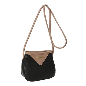 Minimalist black and beige contrast bucket bag with gold metal trim and long strap