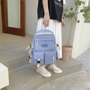 Close-up of lightweight purple nylon school backpack with functional double front pockets