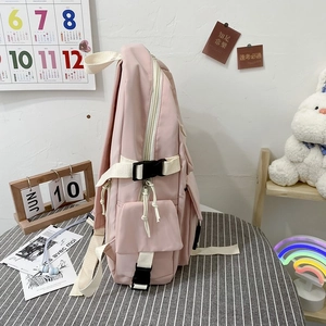 Detail of pink school backpack with multi-layer storage pockets and adjustable straps