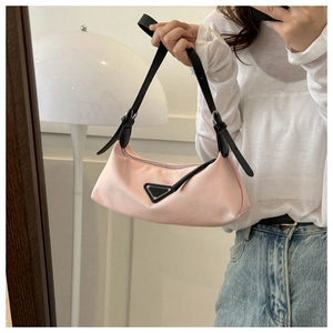 Detail of pink nylon underarm bag with metal triangle logo and leather strap