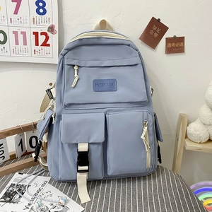 Detail of light blue student backpack with multiple pockets and durable buckles