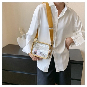 Detailansicht einer transparenten PVC-Umhängetasche mit gelbem, breitem Segeltuchgurt