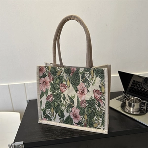 Retro canvas tote bag with pink floral embroidery and beige handles for daily commute