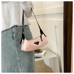 Pink minimalist nylon hobo bag with a signature black triangular logo detail