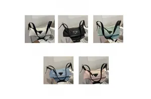 Detail view of colorful nylon shoulder bags with metal triangle logo and leather straps