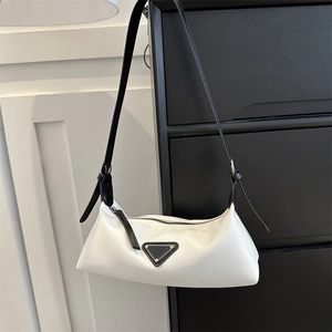Minimalist white underarm bag with black shoulder strap and triangle metal logo