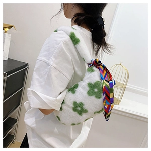 Detail of white plush floral shoulder bag with a decorative colorful silk scarf handle