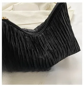 Detailed view of black pleated fabric texture with zipper on a chic women handbag