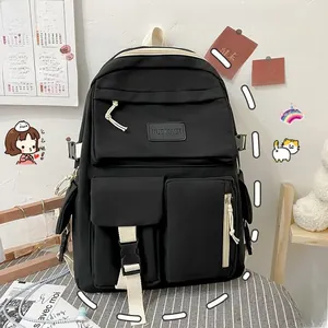 Close-up of black nylon backpack with multi-pockets, brand label and buckle details