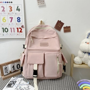 Pink nylon school backpack featuring multiple functional buckle pockets and sleek zip design