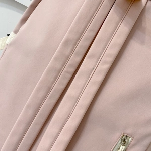 Close-up of reinforced shoulder straps with precise double stitching on a pink school backpack