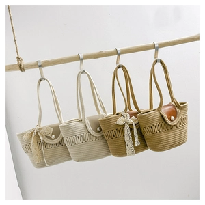 Close-up of woven handbags featuring leather flaps, pearl buckles and lace bow accents