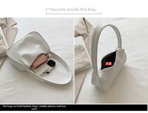 Detailansicht des geräumigen Hauptfachs der weißen Schultertasche aus Kunstleder