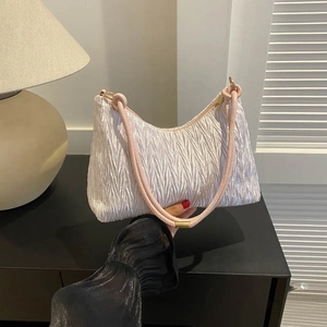 Ruched shoulder bag in creamy white with pink handle and elegant pleated texture