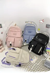 Detail of four colorful school backpacks with multiple pockets and white buckles