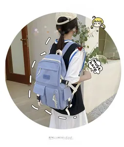 Detail view of light blue nylon backpack with adjustable white straps and plastic buckles