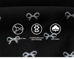 Detail of soft black knit fabric with white bow patterns, skin-friendly and formaldehyde-free