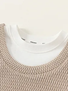 Mädchen Strickweste in Beige über weißem Langarmshirt mit einem Schicht-Design-Look
