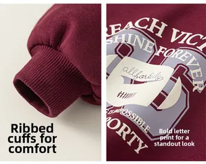 Close-up of ribbed cuffs and REACH VICTORY letter print on a burgundy sweatshirt