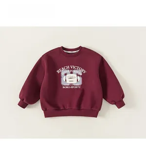 Detail of burgundy fleece sweatshirt with Reach Victory collegiate letter printing