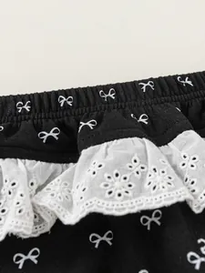 Girls Korean style black joggers with white bow patterns and elegant lace trim details