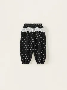 Girls black cotton joggers with white bow print and delicate lace ruffle waistband