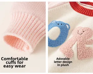 Detail of soft ribbed pink cuffs and plush letter embroidery on kids knit sweater