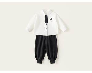 Detail of boys' white shirt with imsbobo dog embroidery and black tie, academic style