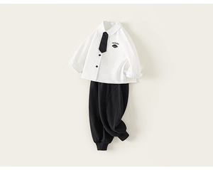Detail of white long-sleeved shirt with dog graphic and black joggers set for boys