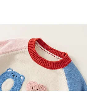 Detail of round ribbed collar and colorful raglan sleeves with bear boucle embroidery
