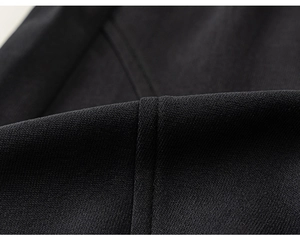Detailed macro shot of premium black knit fabric texture and high-quality stitching on set