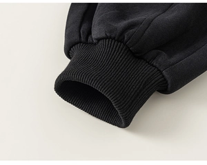 Detail of premium ribbed cuffs and tight knitting on boys black long sleeve suit set