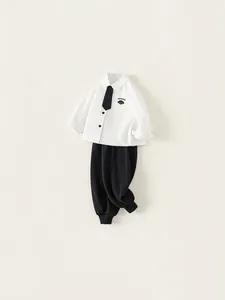 Classic school style boys white shirt with black tie and trousers set for toddlers