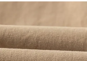 Close-up detail of soft khaki twill fabric texture for children's casual trousers