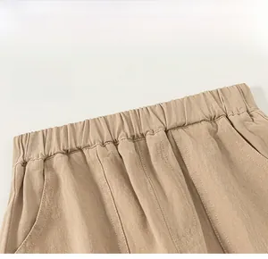 Detail of boys casual trousers featuring a comfortable elastic waistband and twill fabric