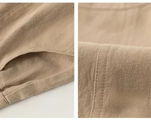 Detailed view of khaki cotton pants featuring side pockets and reinforced stitching detail