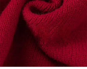 Close-up of red girls' knitted cardigan fabric showing soft texture and premium weave
